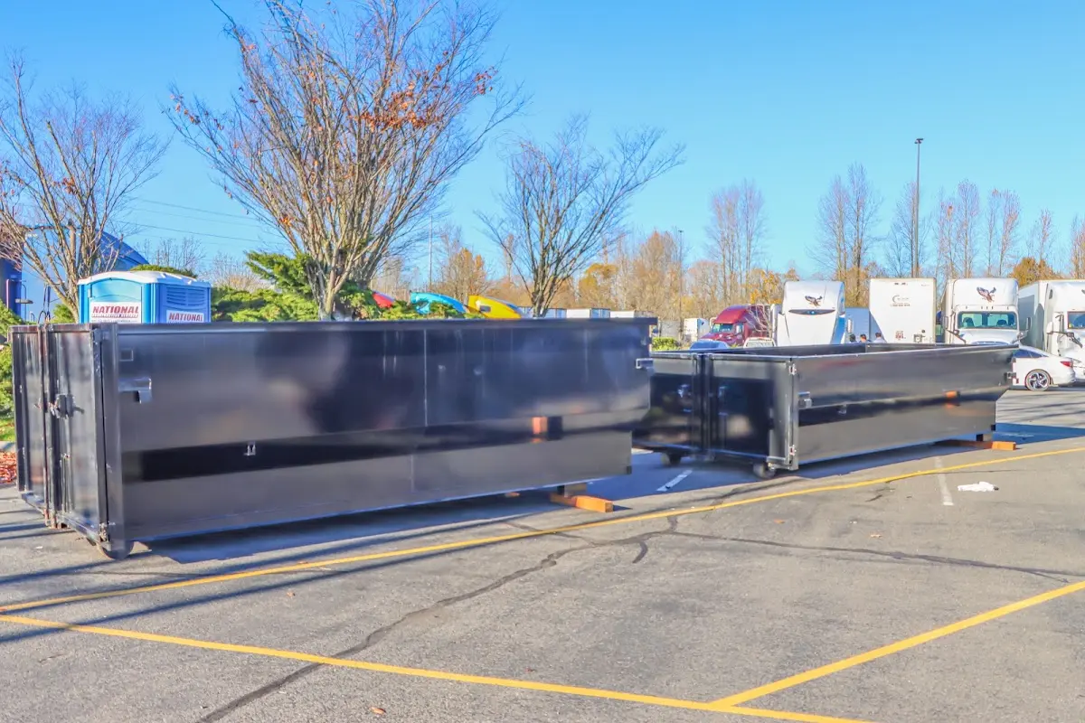 Professional dumpster rental service with roll-off container on residential driveway in Caldwell